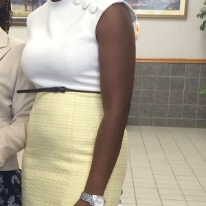 White and yellow knee length dress.